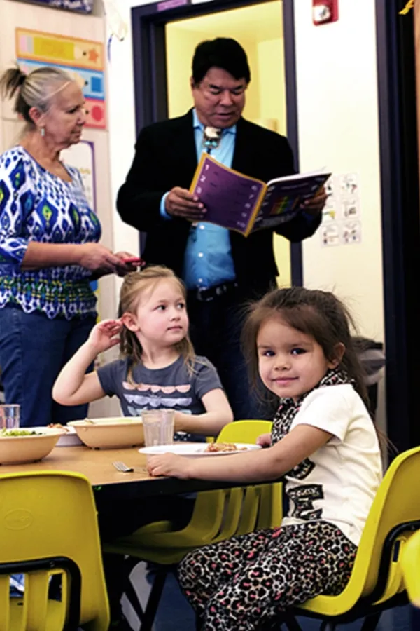 A photo of Ray Halbritter reading to children