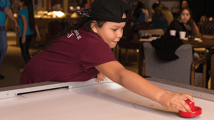 Boy playing air hockey